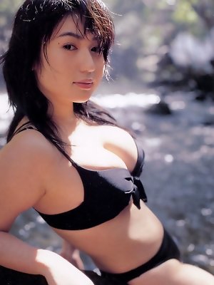 Beautiful sultry asian model tantilizes in her skimpy bikini